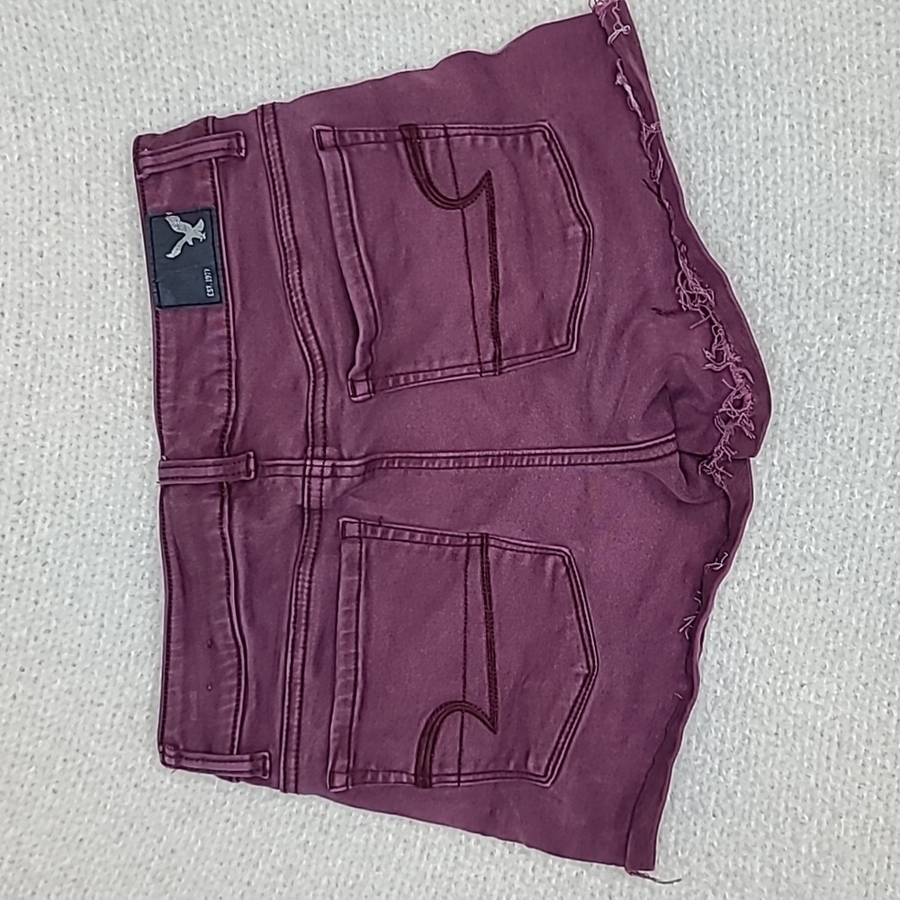 AE Next Level Low Rise Cuffed Raw Hem Cotton Denim Shortie Shorts in Burgundy - Picture 13 of 17